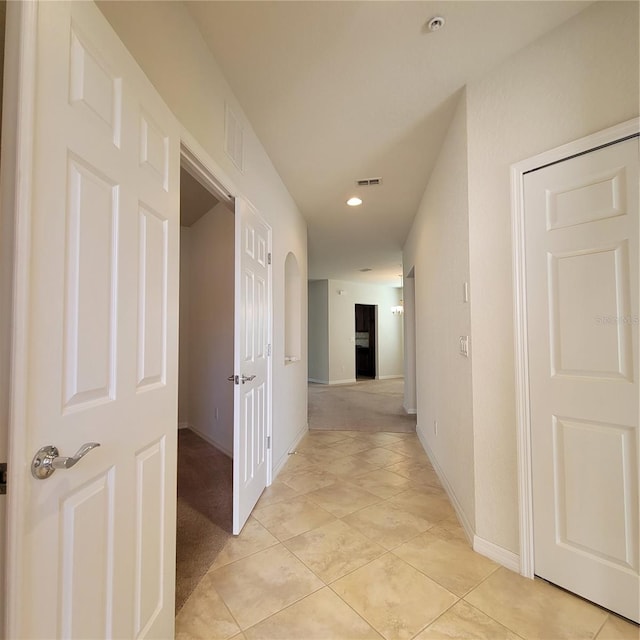 hall featuring light tile patterned floors