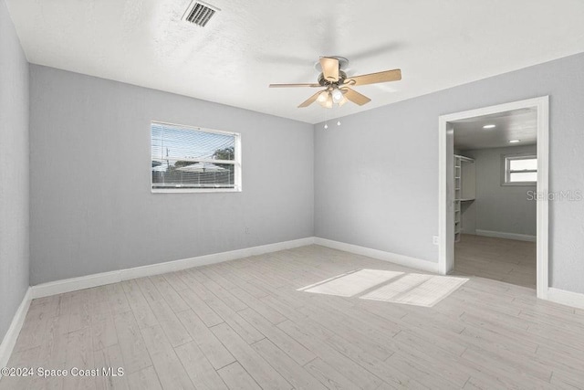 spare room featuring ceiling fan and light hardwood / wood-style flooring