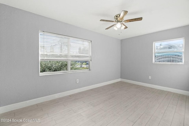 unfurnished room with ceiling fan and light hardwood / wood-style flooring