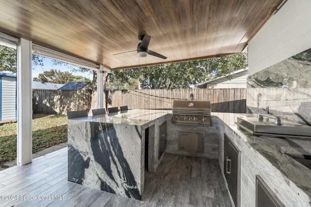 view of patio with area for grilling and ceiling fan