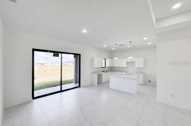 kitchen featuring white cabinets and a center island