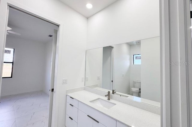 bathroom featuring vanity and toilet