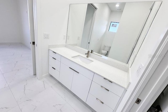 bathroom with vanity and toilet