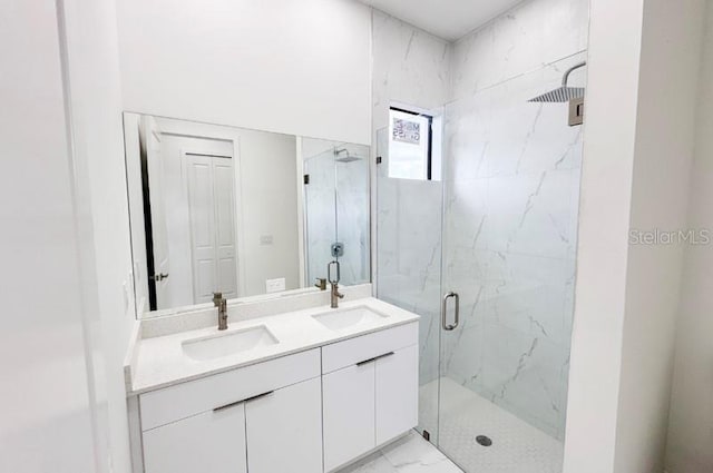 bathroom featuring vanity and an enclosed shower