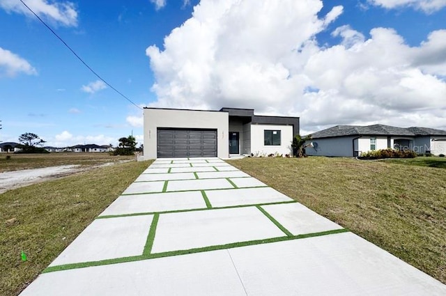 view of front facade featuring a garage and a front lawn