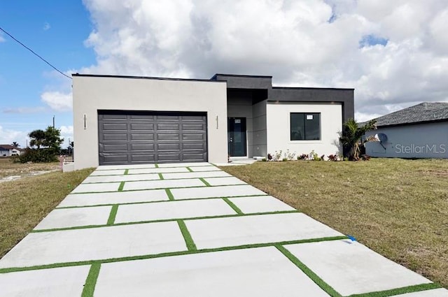 contemporary home featuring a garage and a front lawn