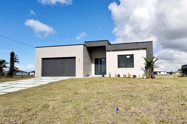 view of front of house featuring a garage and a front lawn