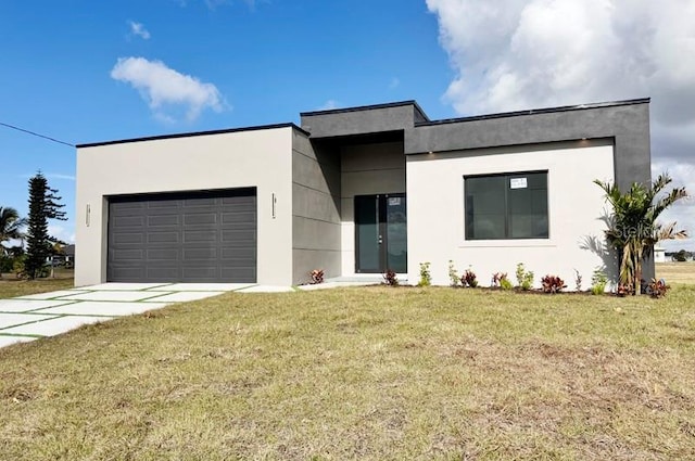 view of front facade with a front yard and a garage