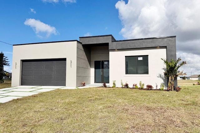 view of front of home with a garage and a front lawn