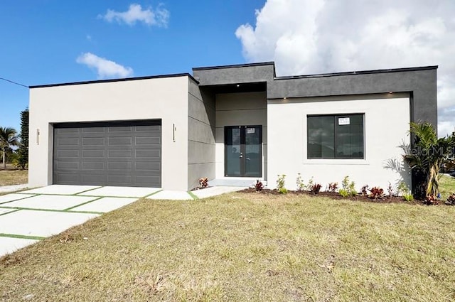 view of front of house with a front yard and a garage