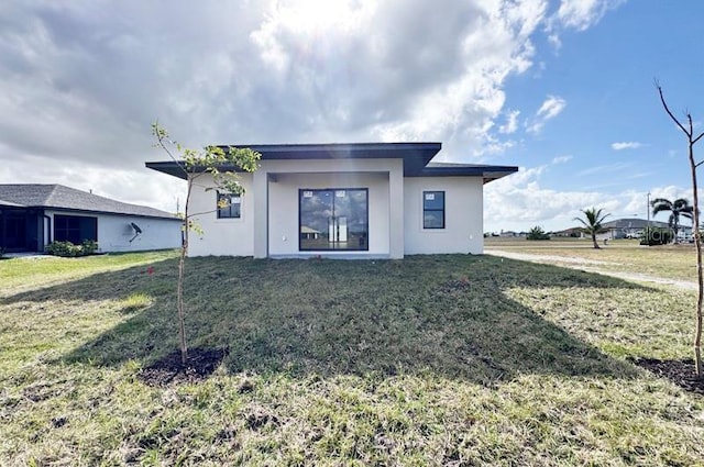 rear view of house with a lawn