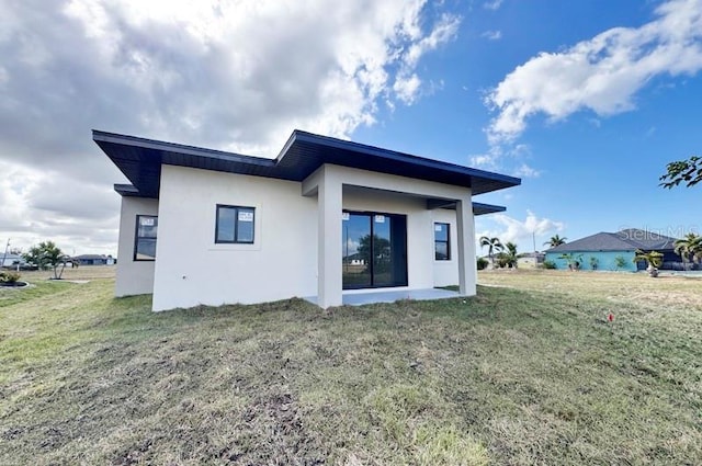 rear view of property with a yard