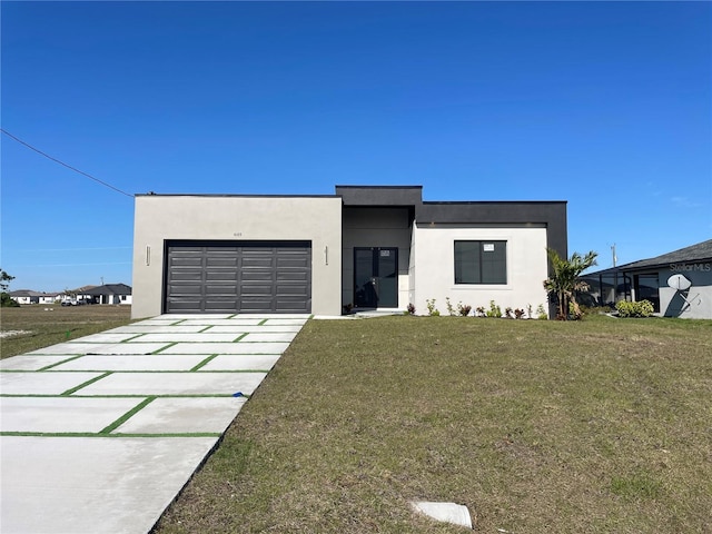 contemporary home featuring a garage and a front lawn