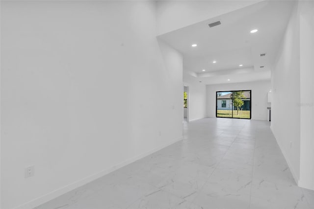 unfurnished room featuring baseboards, marble finish floor, visible vents, and recessed lighting