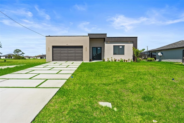 contemporary home featuring stucco siding, driveway, a front lawn, and a garage