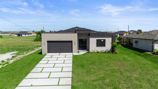 view of front of home with stucco siding, an attached garage, driveway, and a front yard