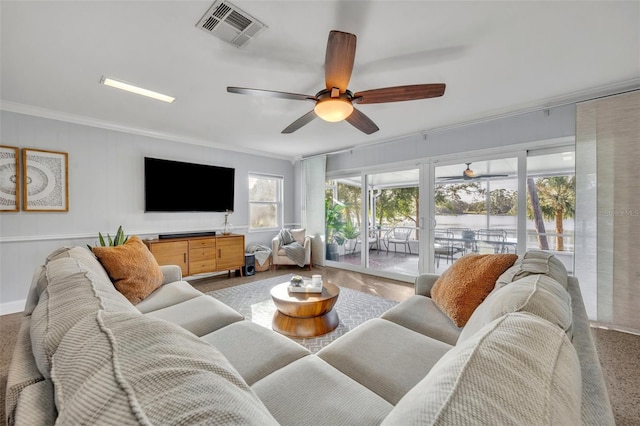 living room featuring ornamental molding and ceiling fan