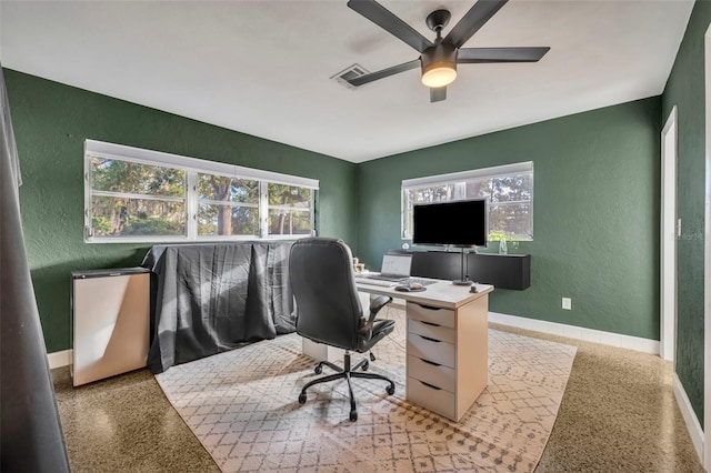 office with ceiling fan and plenty of natural light