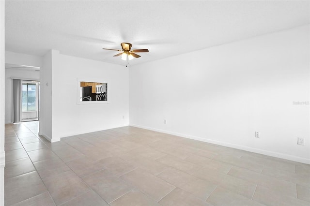 empty room with light tile patterned floors, a textured ceiling, and ceiling fan