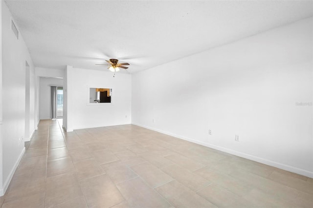 unfurnished room featuring a textured ceiling, ceiling fan, and light tile patterned flooring