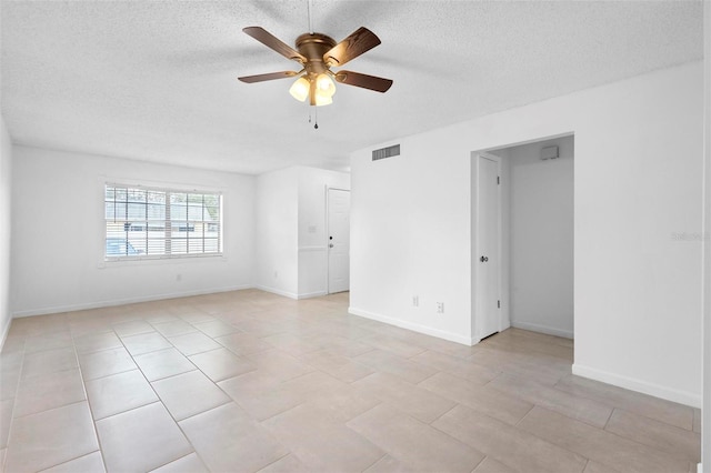 tiled empty room with a textured ceiling and ceiling fan