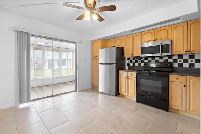 kitchen featuring decorative backsplash, appliances with stainless steel finishes, a textured ceiling, ceiling fan, and light tile patterned floors