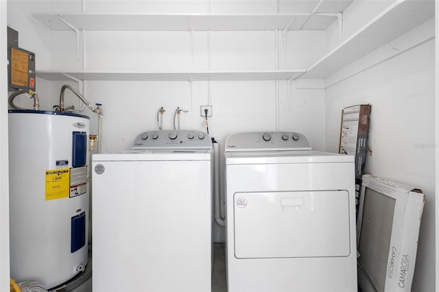 washroom with washing machine and dryer and electric water heater