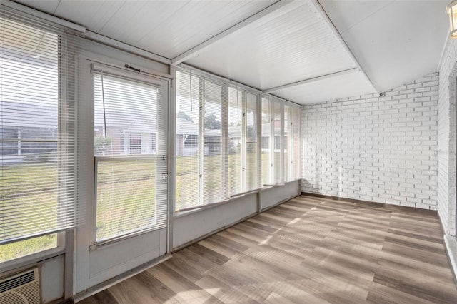 unfurnished sunroom featuring a healthy amount of sunlight and lofted ceiling