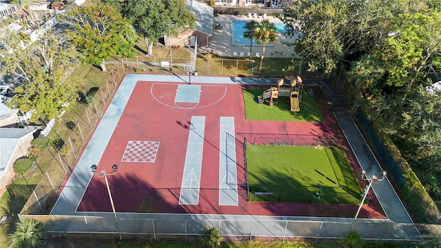 view of basketball court with a playground