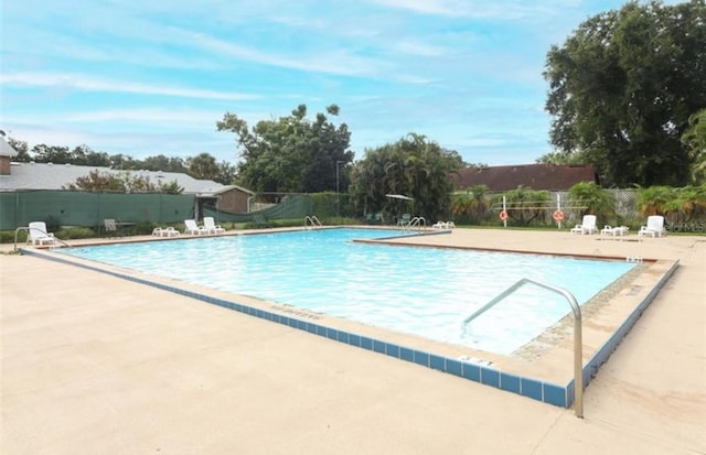 view of swimming pool with a patio area