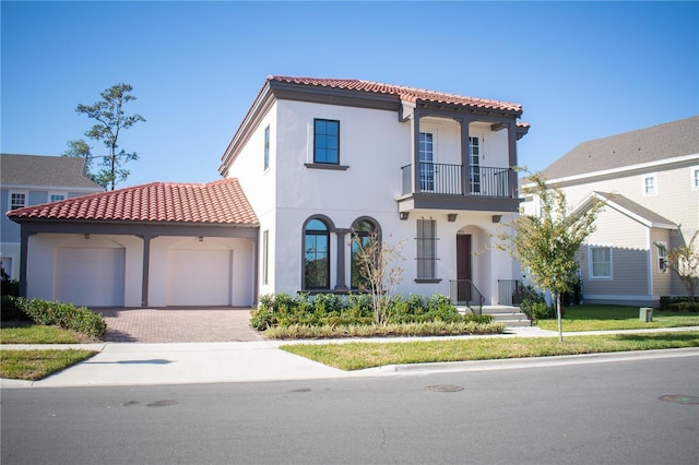 mediterranean / spanish-style home featuring a balcony and a garage