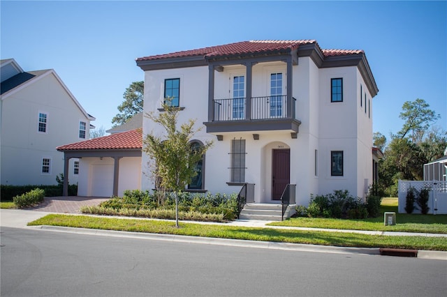 mediterranean / spanish home featuring a front yard