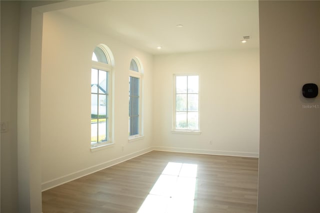 spare room with light hardwood / wood-style flooring