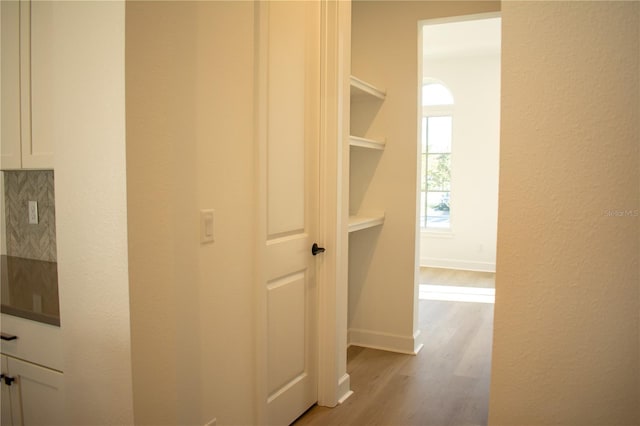 corridor with light hardwood / wood-style floors