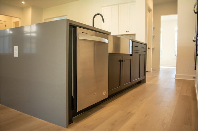 kitchen with white cabinets and light hardwood / wood-style floors