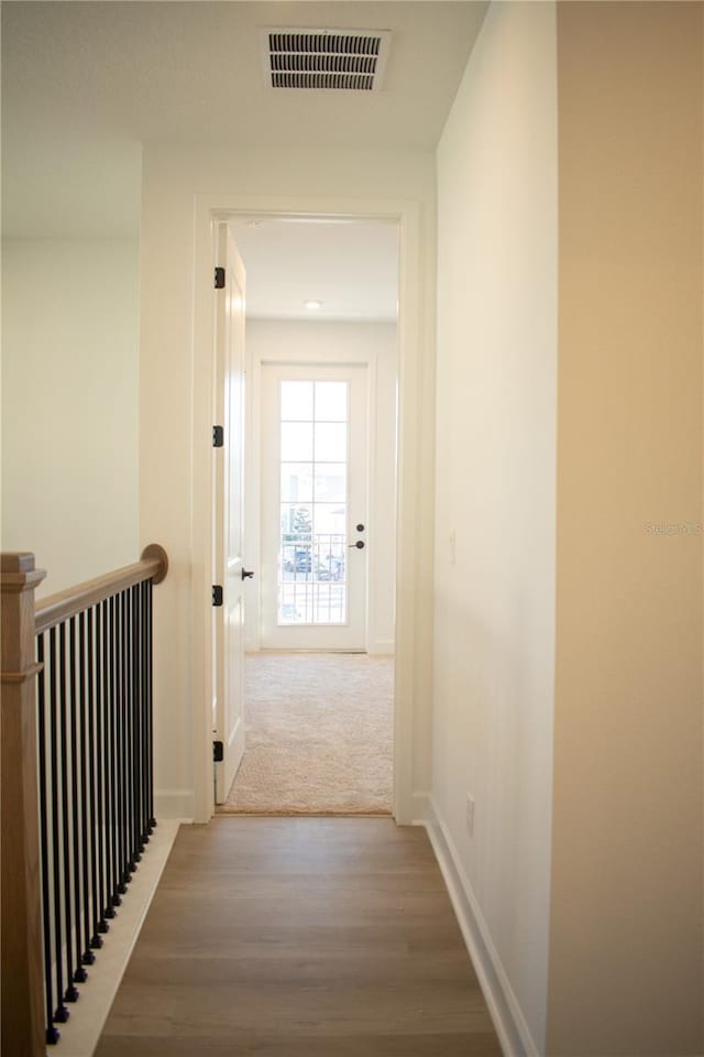 hall with hardwood / wood-style floors