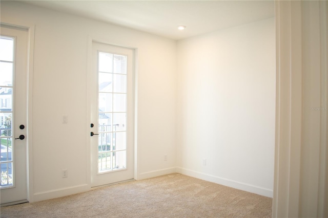 entryway featuring light carpet