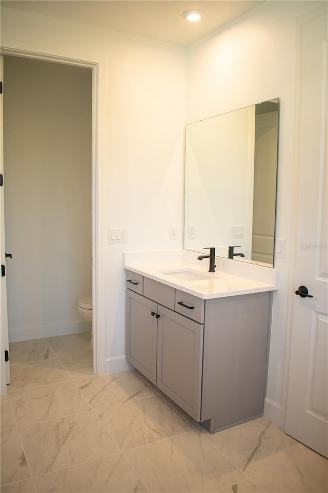 bathroom featuring vanity and toilet