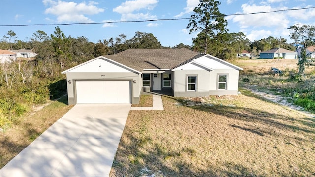 view of front of property featuring a front lawn and a garage