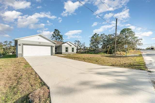 view of front of home featuring a front lawn and a garage