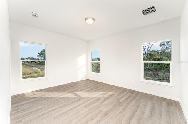 unfurnished room with light hardwood / wood-style flooring