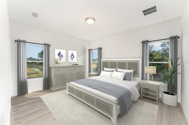 bedroom featuring light hardwood / wood-style floors and multiple windows