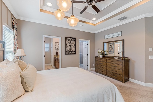 bedroom featuring connected bathroom, a raised ceiling, ceiling fan, and ornamental molding