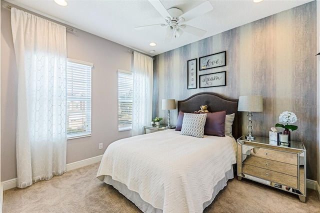 bedroom with ceiling fan and light carpet