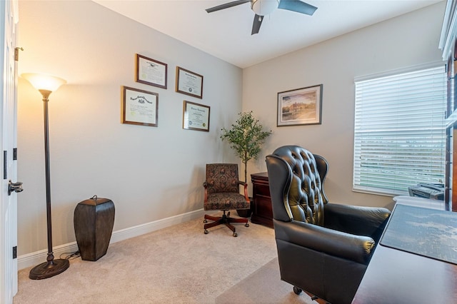 office space featuring light carpet and ceiling fan