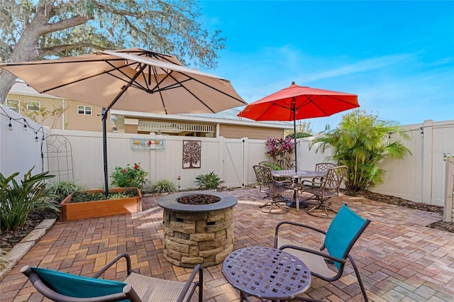 view of patio / terrace with an outdoor fire pit