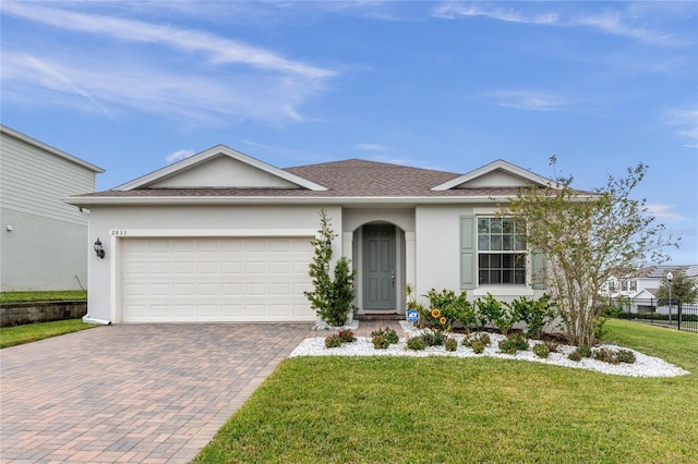 single story home with a garage and a front yard