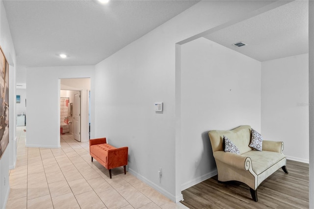 living area featuring a textured ceiling