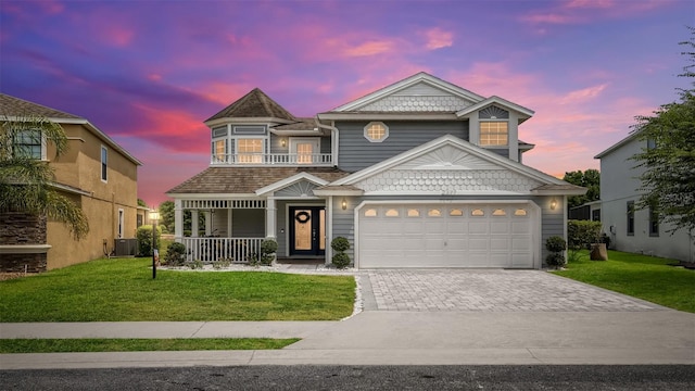 2377 Victoria Dr, Davenport, FL 33837 - view of front of property with a porch, decorative driveway, a front lawn, and a balcony