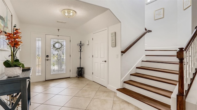 2377 Victoria Dr, Davenport, FL 33837 - foyer with stairway, light tile patterned floors, and a chandelier